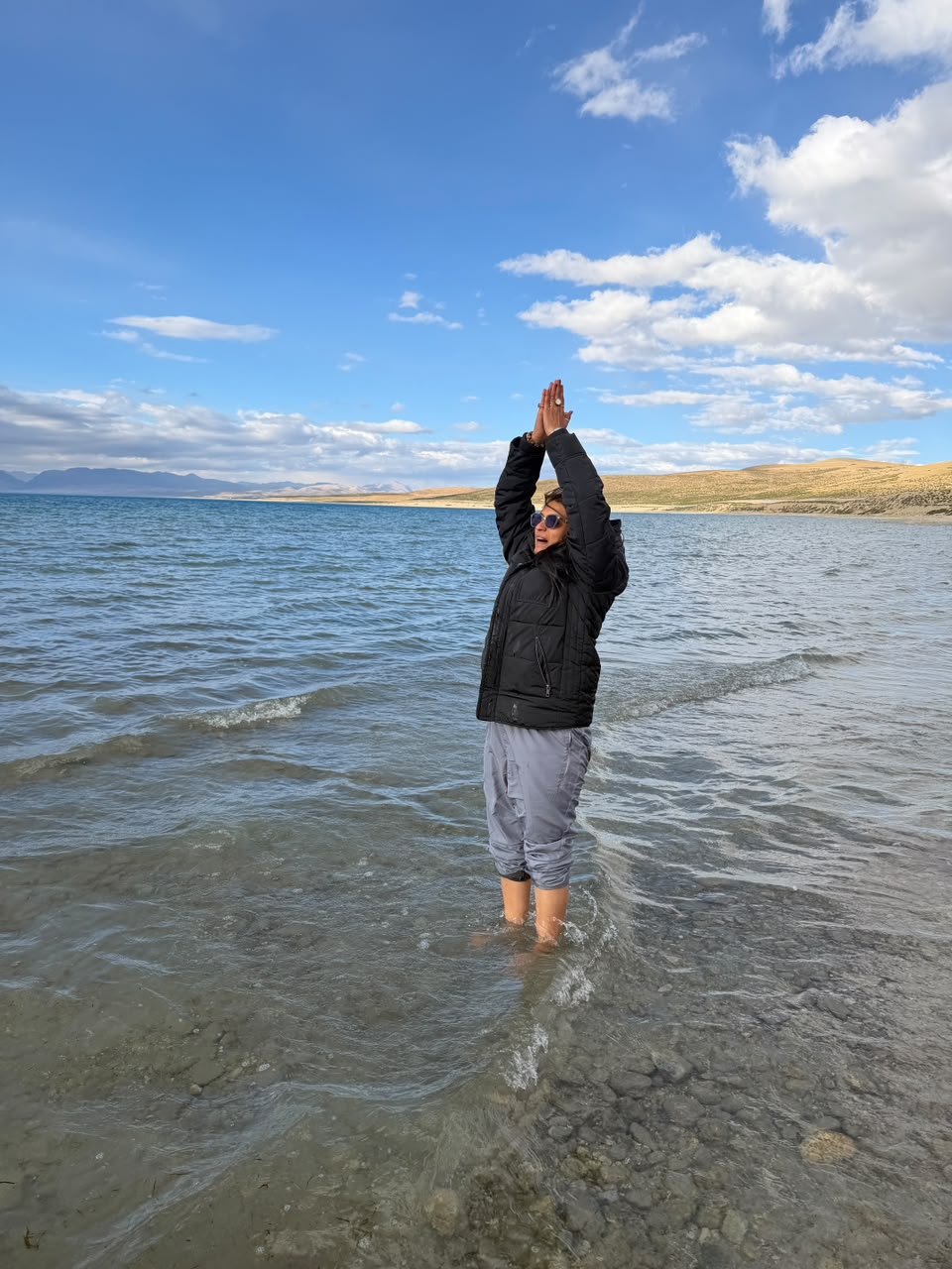 Standing in the waters below the snow-covered peaks